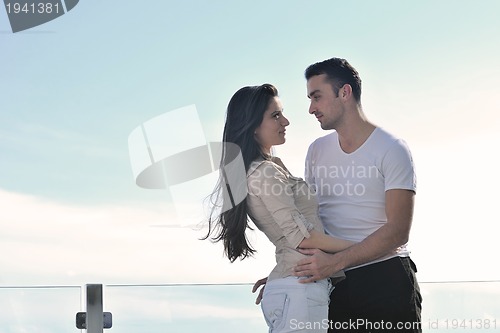 Image of couple relaxing on balcony