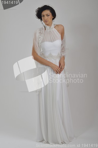 Image of elegant woman in fashionable dress posing in the studio