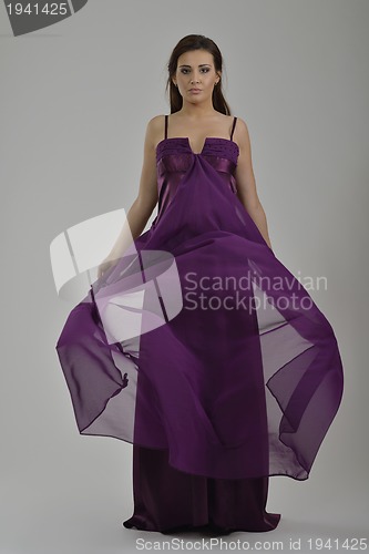 Image of elegant woman in fashionable dress posing in the studio