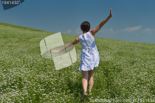 Image of Young happy woman in green field
