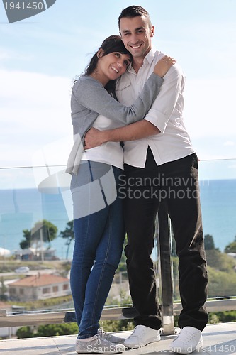 Image of couple relaxing on balcony