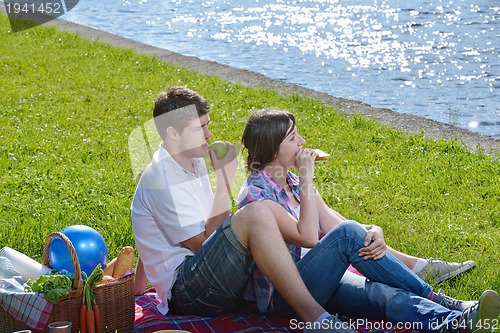 Image of happy young couple having a picnic outdoor
