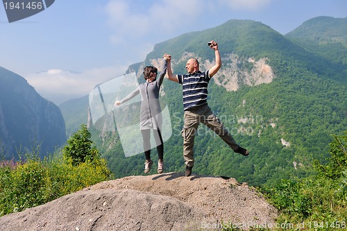 Image of happy young couple jumping in the air
