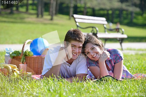 Image of happy young couple having a picnic outdoor