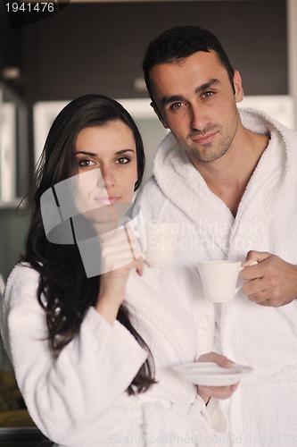 Image of Young love couple taking fresh morning cup of coffee