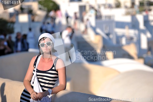 Image of Greek woman on the streets of Oia, Santorini, Greece