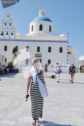 Image of Greek woman on the streets of Oia, Santorini, Greece