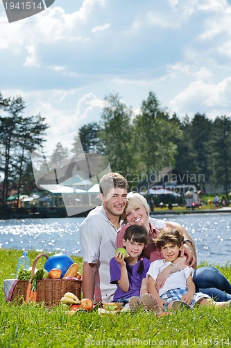 Image of Happy family playing together in a picnic outdoors