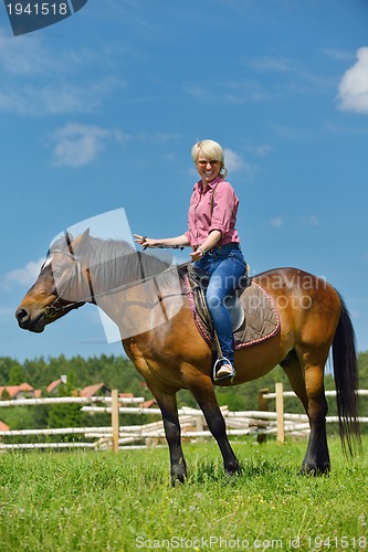 Image of happy woman  on  horse