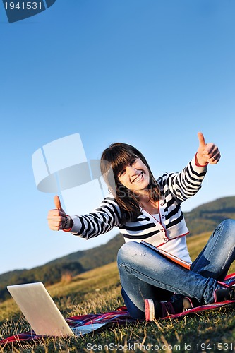 Image of young teen girl work on laptop outdoor