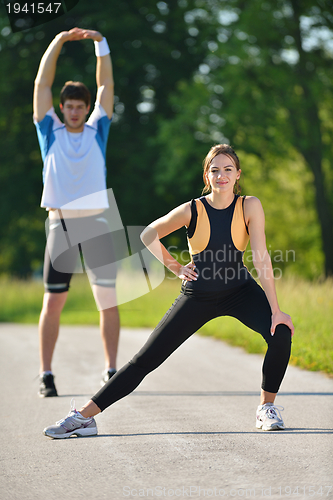 Image of Couple doing stretching exercise  after jogging