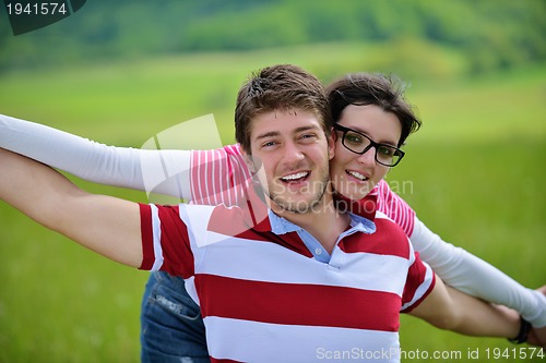 Image of Portrait of romantic young couple smiling together outdoor