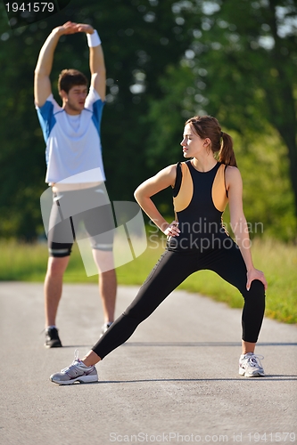 Image of Couple doing stretching exercise  after jogging