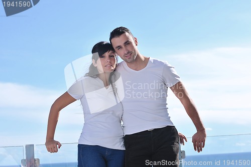 Image of couple relaxing on balcony