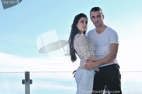 Image of couple relaxing on balcony