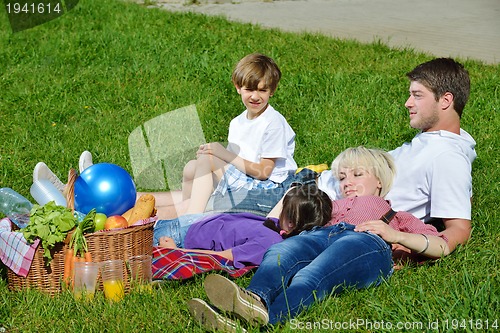 Image of Happy family playing together in a picnic outdoors