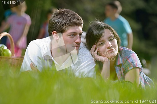 Image of happy young couple having a picnic outdoor