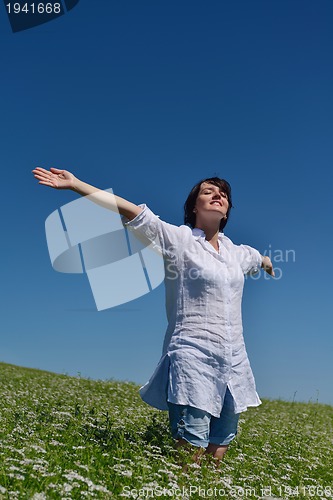 Image of young woman in wheat field at summer