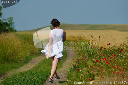 Image of Young happy woman in green field