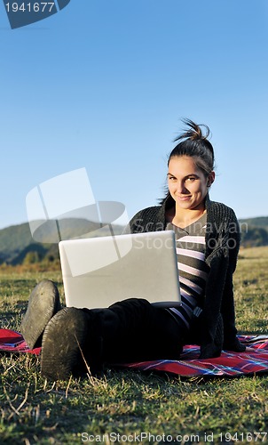 Image of young teen girl work on laptop outdoor