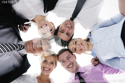 Image of business people with their heads together