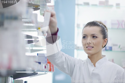 Image of pharmacist chemist woman standing in pharmacy drugstore
