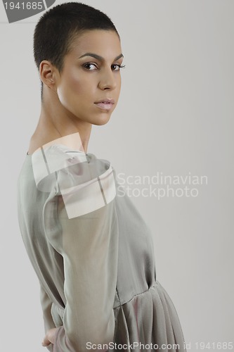 Image of elegant woman in fashionable dress posing in the studio