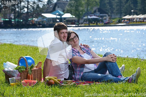 Image of happy young couple having a picnic outdoor