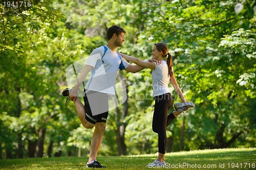 Image of Couple doing stretching exercise  after jogging