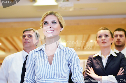 Image of business woman standing with her staff at conference