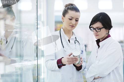 Image of team of pharmacist chemist woman  in pharmacy drugstore