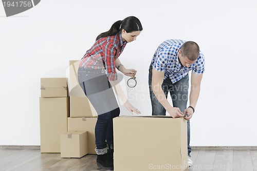 Image of Young couple moving in new home