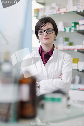 Image of pharmacist chemist woman standing in pharmacy drugstore