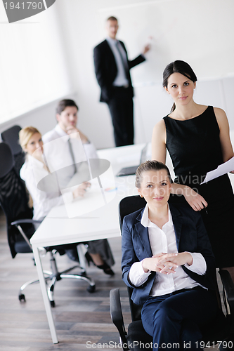 Image of business woman with her staff in background