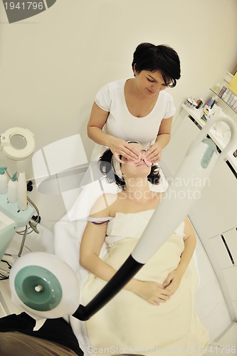 Image of woman with facial mask in cosmetic studio