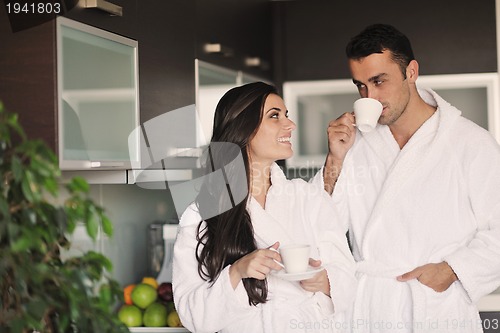 Image of Young love couple taking fresh morning cup of coffee