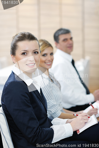 Image of business woman standing with her staff at conference
