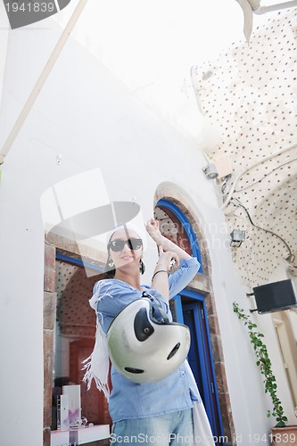 Image of Greek woman on the streets of Oia, Santorini, Greece