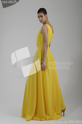 Image of elegant woman in fashionable dress posing in the studio