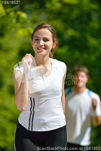 Image of Young couple jogging