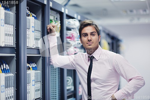 Image of young it engeneer in datacenter server room