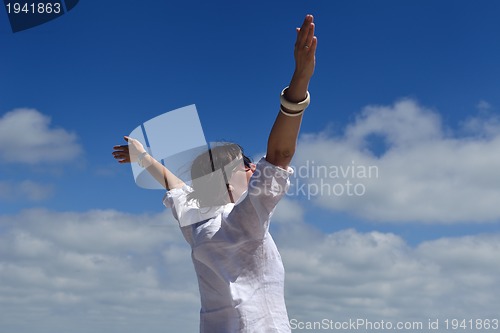 Image of happy young woman with spreading arms to sky