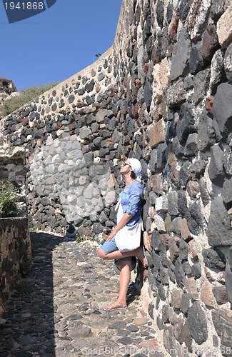 Image of Greek woman on the streets of Oia, Santorini, Greece