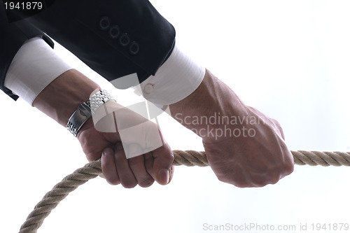 Image of business man with rope isolated on white background