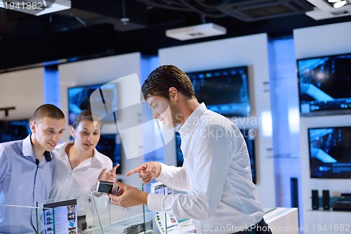 Image of Young couple in consumer electronics store