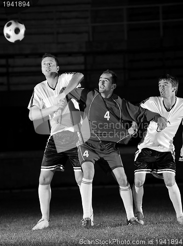 Image of football players in action for the ball