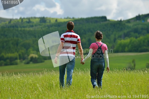 Image of Portrait of romantic young couple smiling together outdoor