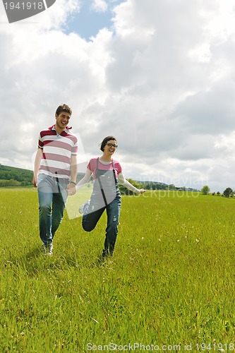 Image of Portrait of romantic young couple smiling together outdoor