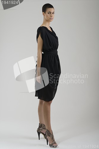 Image of elegant woman in fashionable dress posing in the studio