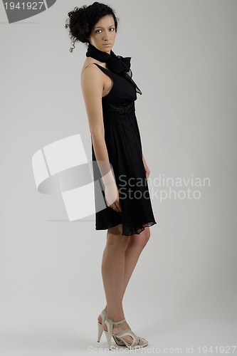 Image of elegant woman in fashionable dress posing in the studio